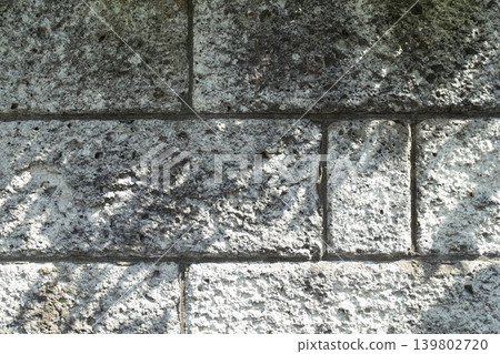 The shadows of leaves falling on the Oya stone block wall The shadows of leaves falling on the Oya stone block wall 139802720