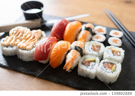 Fresh sushi assortment with salmon maki and nigiri Fresh sushi assortment with salmon maki and nigiri 139802889
