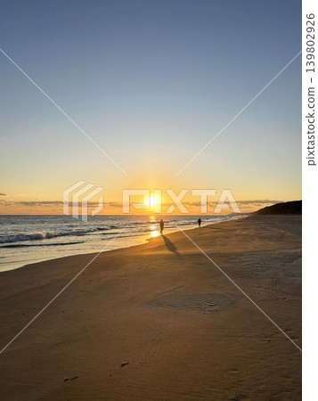 A view of the sunset from the shoreline. A view of the sunset from the shoreline. 139802926