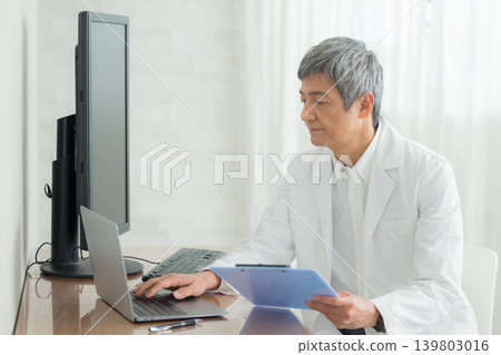 Middle-aged man wearing a white coat Middle-aged man wearing a white coat 139803016