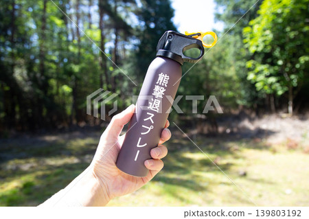 The hands of the person holding bear repellent spray The hands of the person holding bear repellent spray 139803192
