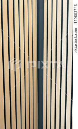 Minimalist background showing two sections of light oak wood slats on dark acoustic panels in a corner Minimalist background showing two sections of light oak wood slats on dark acoustic panels in a corner 139803748