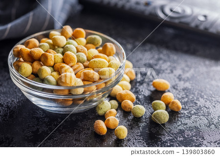 Glass Bowl of Colorful Coated Peanuts and Crunchy Snack on Dark Tabletop Glass Bowl of Colorful Coated Peanuts and Crunchy Snack on Dark Tabletop 139803860