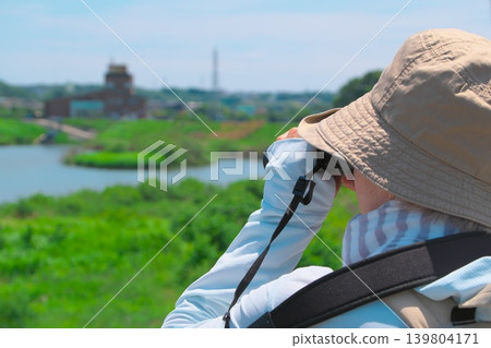 Woman enjoying bird watching 139804171