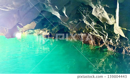 The Blue Grotto (Hachinohe Cave) in Jodogahama, Miyako City, Iwate Prefecture, where the water surface and rock face shimmer emerald green in the morning sunlight. The Blue Grotto (Hachinohe Cave) in Jodogahama, Miyako City, Iwate Prefecture, where the water surface and rock face shimmer emerald green in the morning sunlight. 139804443