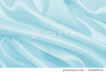 Smooth elegant blue silk or satin luxury cloth texture as abstract background. Luxurious background design Smooth elegant blue silk or satin luxury cloth texture as abstract background. Luxurious background design 139804542