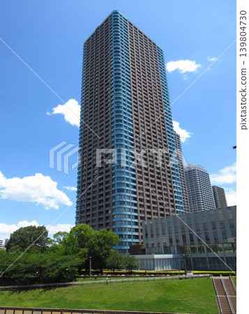 Century Park Tower, towering over the waterfront in Tsukuda, Chuo Ward, Tokyo, and the blue sky. Century Park Tower, towering over the waterfront in Tsukuda, Chuo Ward, Tokyo, and the blue sky. 139804730