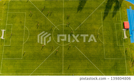 Topdown perspective of soccer match. An aerial shot capturing shadows and structures during soccer game 139804806