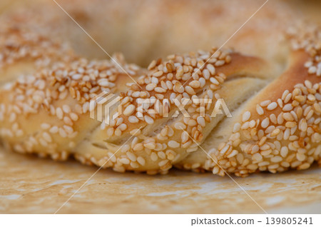 Golden braided bread adorned with sesame seeds showcases traditional baking artistry in a warm kitchen setting Golden braided bread adorned with sesame seeds showcases traditional baking artistry in a warm kitchen setting 139805241