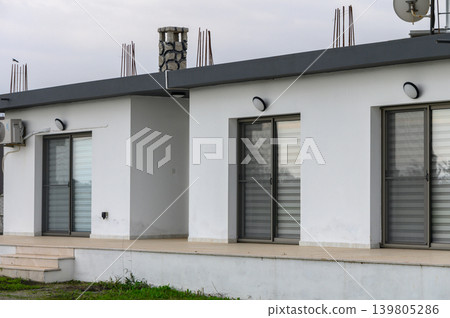 Modern architecture meets serene landscape with minimalist design on cloudy day in suburban environment Modern architecture meets serene landscape with minimalist design on cloudy day in suburban environment 139805286