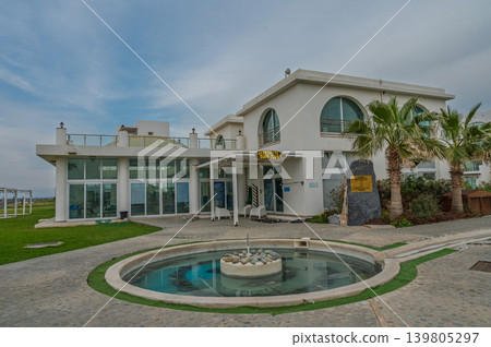 Modern beachfront villa with serene water features and inviting spaces in a stunning coastal setting Modern beachfront villa with serene water features and inviting spaces in a stunning coastal setting 139805297
