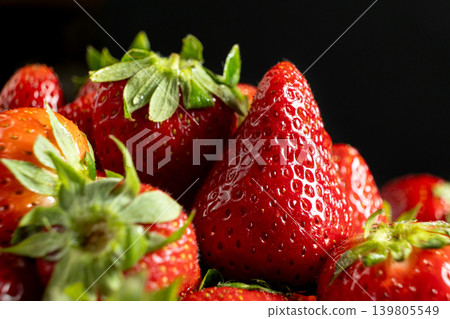 Ripe strawberries on dark background macro Ripe strawberries on dark background macro 139805549