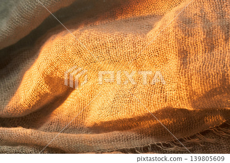 Natural burlap fabric texture in warm golden sunlight macro Natural burlap fabric texture in warm golden sunlight macro 139805609