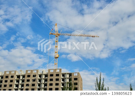 Outdoor day photography of a construction site showing a heavy lift crane arm extended Outdoor day photography of a construction site showing a heavy lift crane arm extended 139805623