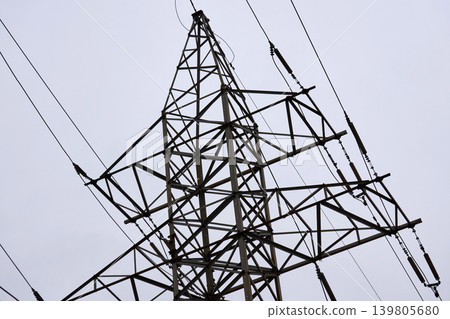 Complex steel truss construction of a radio tower against overcast sky Complex steel truss construction of a radio tower against overcast sky 139805680