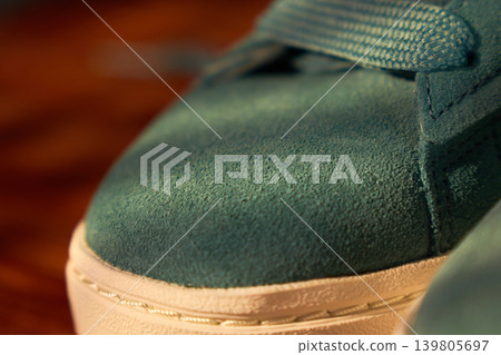 Close analysis of suede footwear. Close scrutiny of suede shoes highlighting craftsmanship details and signs of usage wear Close analysis of suede footwear. Close scrutiny of suede shoes highlighting craftsmanship details and signs of usage wear 139805697