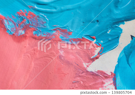 A vibrant macro shot of pink and azure oil paint mixing on a canvas. The image highlights the heavy impasto texture A vibrant macro shot of pink and azure oil paint mixing on a canvas. The image highlights the heavy impasto texture 139805704