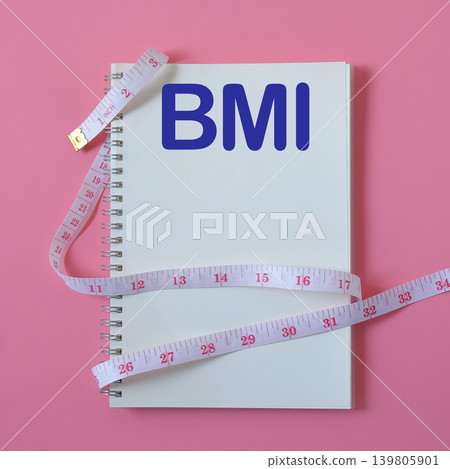 BMI text write on book note with measuring tape ,pen on background. BMI text write on book note with measuring tape ,pen on background. 139805901