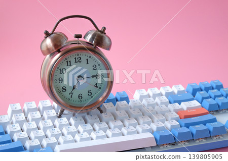 Vintage Alarm clock on computer keyboard . Vintage Alarm clock on computer keyboard . 139805905