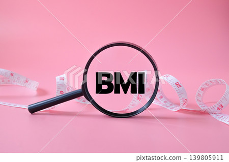 BMI text on magnifying glass with measuring tape. BMI text on magnifying glass with measuring tape. 139805911