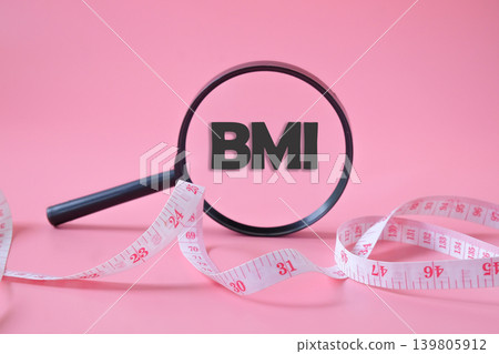 BMI text on magnifying glass with measuring tape. BMI text on magnifying glass with measuring tape. 139805912