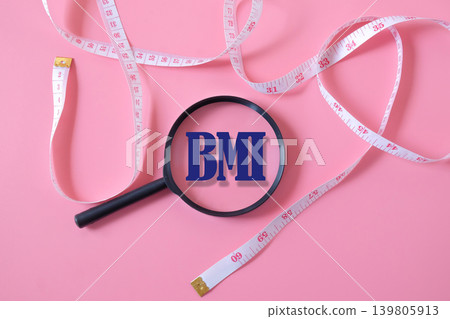 BMI text on magnifying glass with measuring tape. BMI text on magnifying glass with measuring tape. 139805913