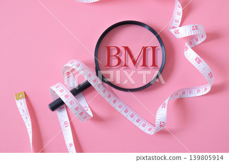 BMI text on magnifying glass with measuring tape. BMI text on magnifying glass with measuring tape. 139805914
