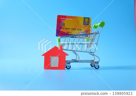 Credit card and small shopping cart on background. Credit card and small shopping cart on background. 139805921