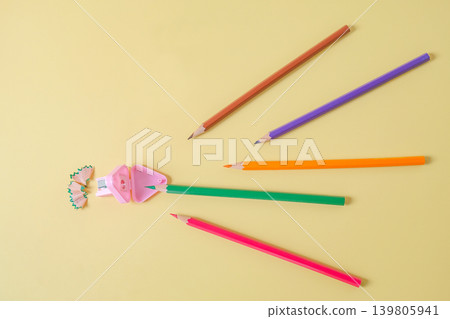 Color pencils go straight to sharpener on background. 139805941
