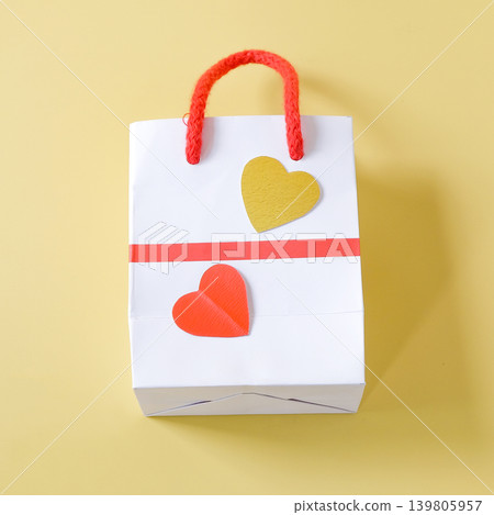 Duo hearts on Empty shopping bag, Front view on background. Duo hearts on Empty shopping bag, Front view on background. 139805957
