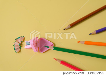 Color pencils go straight to sharpener on background. Color pencils go straight to sharpener on background. 139805958