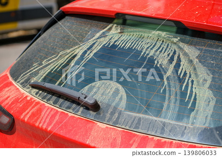 Rear car window covered with thick pollen streaks, intense spring bloom causing allergies, environmental exposure and seasonal health concept. Rear car window covered with thick pollen streaks, intense spring bloom causing allergies, environmental exposure and seasonal health concept. 139806033