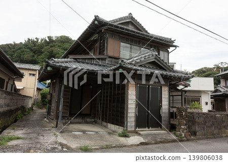 The beauty of traditional Japanese architecture: A charming old wooden house with a majestic hip-and-gable roof. 139806038