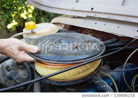 Mechanic replacing car air filter during vehicle maintenance 139806158