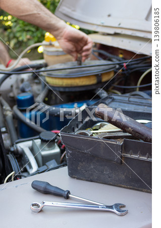 Man repairing car engine with mechanic tools Man repairing car engine with mechanic tools 139806185
