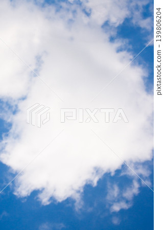 White fluffy cumulonimbus clouds floating in a vibrant blue sky on a bright sunny summer day, showcasing weather patterns and clear atmospheric conditions White fluffy cumulonimbus clouds floating in a vibrant blue sky on a bright sunny summer day, showcasing weather patterns and clear atmospheric conditions 139806204