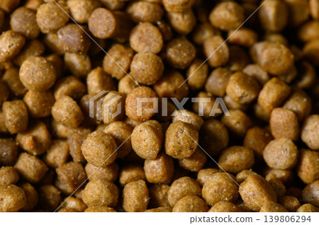 Nourishing pet food pellets in a close-up view showcasing their texture Nourishing pet food pellets in a close-up view showcasing their texture 139806294