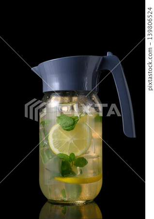 Glass Pitcher with Refreshing Beverage on Black Surface Glass Pitcher with Refreshing Beverage on Black Surface 139806524