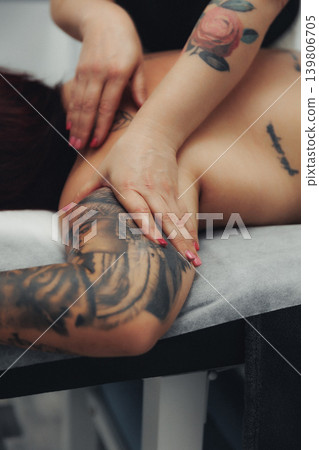 Hands massage a person's arm with care and precision Hands massage a person's arm with care and precision 139806705