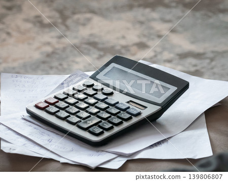 Calculator on paper with number notes. Accounting, finance calculations, tax preparation, budget management and business planning concept. Calculator on paper with number notes. Accounting, finance calculations, tax preparation, budget management and business planning concept. 139806807