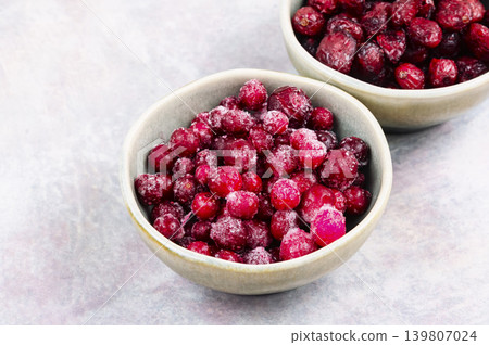 Fresh Frozen Cranberries and Dried Cranberries on Ceramic Plate Fresh Frozen Cranberries and Dried Cranberries on Ceramic Plate 139807024