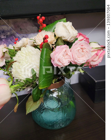 Bouquet of colorful flowers inside glass vase. Arrangement with pink rose, white chrysanthemum and decorative berry. Seasonal floral display for home decor, wedding gift and celebration. Bouquet of colorful flowers inside glass vase. Arrangement with pink rose, white chrysanthemum and decorative berry. Seasonal floral display for home decor, wedding gift and celebration. 139807064