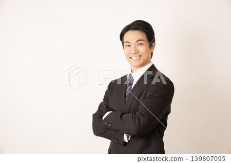 A man with his arms crossed, smiling. A man with his arms crossed, smiling. 139807095