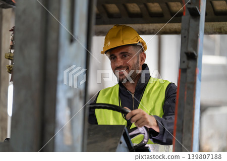 Man worker at forklift driver happy working in industry factory logistic ship. 139807188