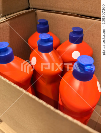 Bright red bottles stacked in a cardboard box during a creative project Bright red bottles stacked in a cardboard box during a creative project 139807360