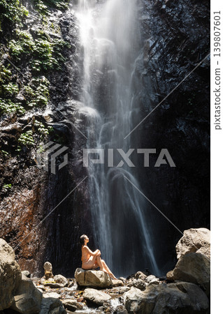 Woman enjoying waterfall, wellness and freedom in wild nature Woman enjoying waterfall, wellness and freedom in wild nature 139807601