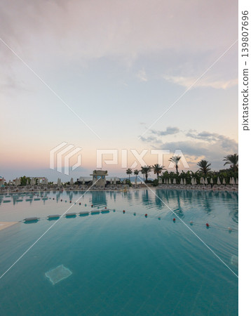 Kemer resort swimming pool reflecting sunset sky Kemer resort swimming pool reflecting sunset sky 139807696