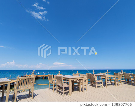 Deck chairs and table overlooking Mediterranean Sea in Kemer, Turkey Deck chairs and table overlooking Mediterranean Sea in Kemer, Turkey 139807706