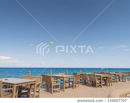 Deck chairs and table overlooking Mediterranean Sea in Kemer, Turkey Deck chairs and table overlooking Mediterranean Sea in Kemer, Turkey 139807707