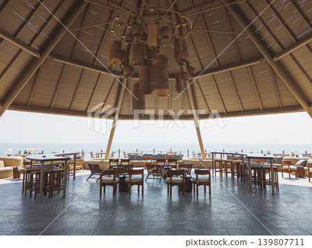 Beach bar pavilion in a Kemer resort offering seaside relaxation Beach bar pavilion in a Kemer resort offering seaside relaxation 139807711